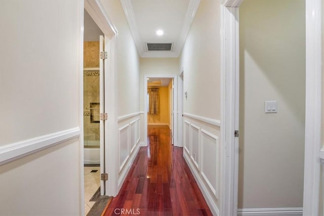 hall with dark hardwood / wood-style floors and ornamental molding