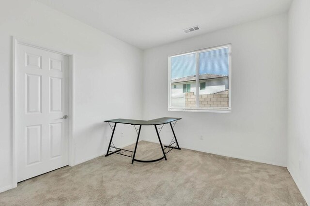 unfurnished room featuring light colored carpet