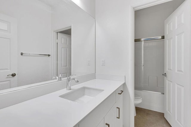 full bathroom featuring enclosed tub / shower combo, tile patterned floors, vanity, and toilet