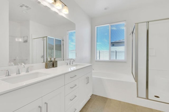 bathroom with tile patterned flooring, vanity, and separate shower and tub