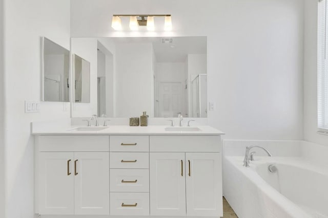 bathroom with shower with separate bathtub and vanity