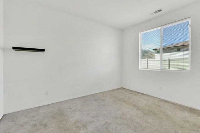 unfurnished room with light carpet