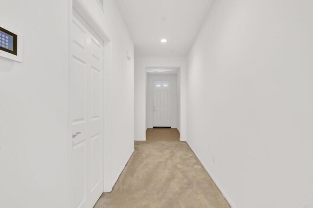 hallway featuring light carpet