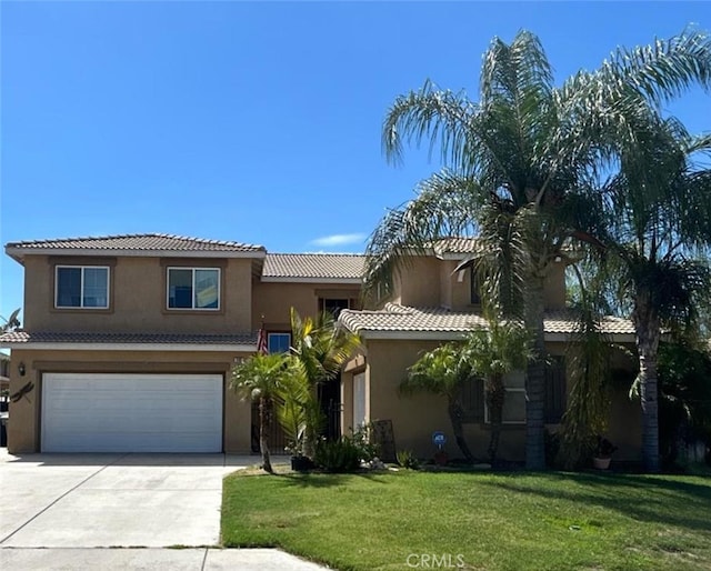 mediterranean / spanish-style house with a garage and a front lawn