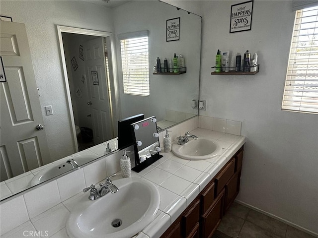 bathroom featuring a healthy amount of sunlight, tile patterned flooring, and vanity