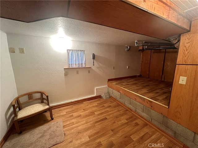 interior space featuring light hardwood / wood-style flooring and a textured ceiling