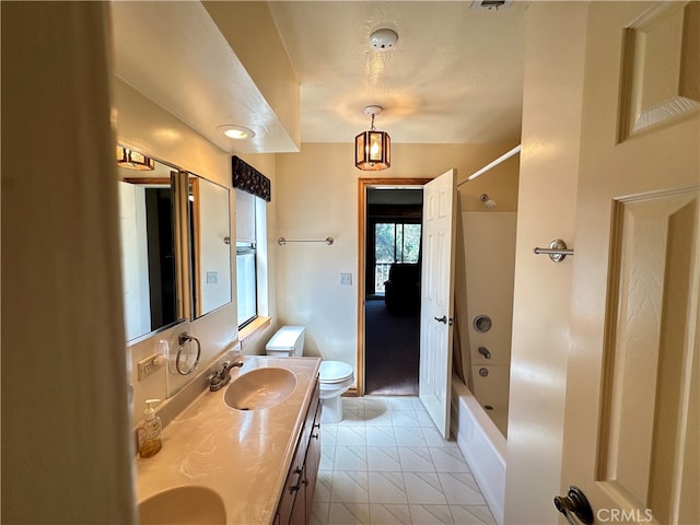 full bathroom with shower / tub combination, vanity, tile patterned flooring, and toilet