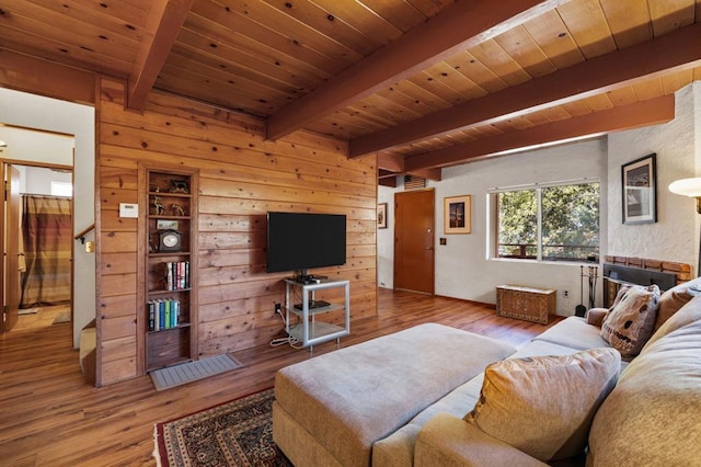 living room with beam ceiling, wooden ceiling, light hardwood / wood-style flooring, and wood walls