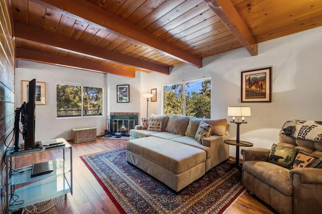 living room featuring beamed ceiling, hardwood / wood-style flooring, and wooden ceiling