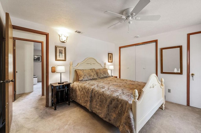 bedroom featuring ceiling fan, light colored carpet, and a closet