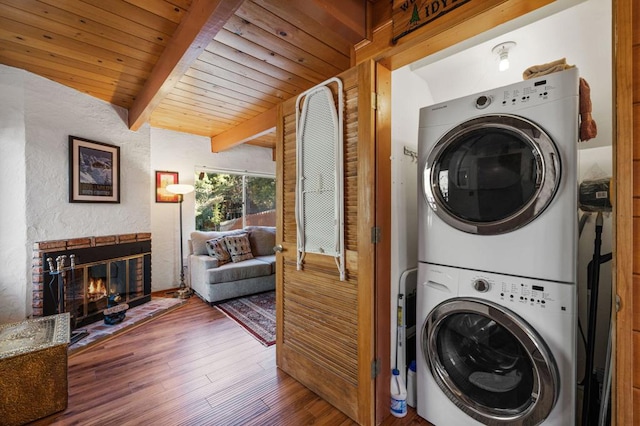 laundry area with wooden ceiling, dark hardwood / wood-style floors, and stacked washing maching and dryer