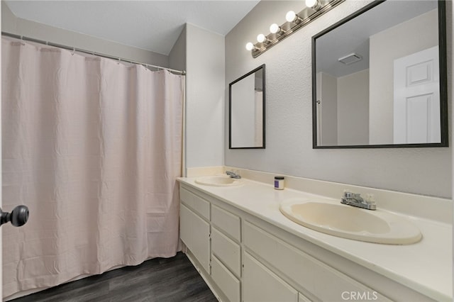 bathroom with vanity and hardwood / wood-style flooring