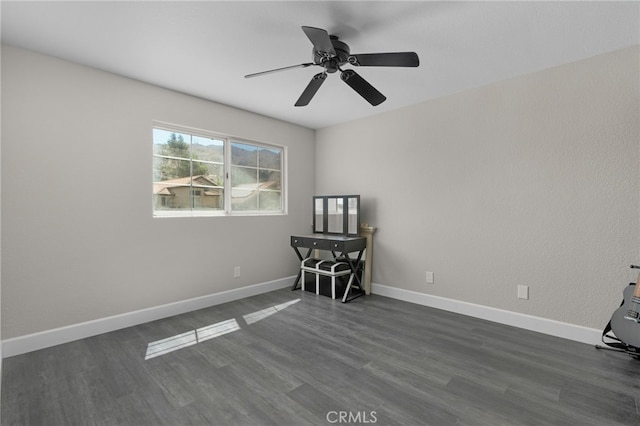 spare room featuring dark hardwood / wood-style floors and ceiling fan