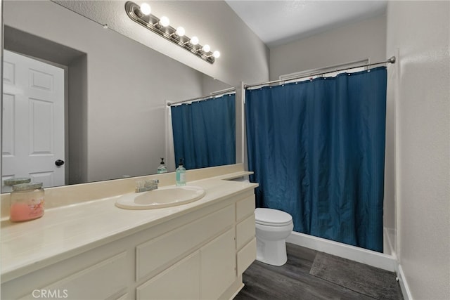 bathroom featuring vanity, hardwood / wood-style flooring, and toilet