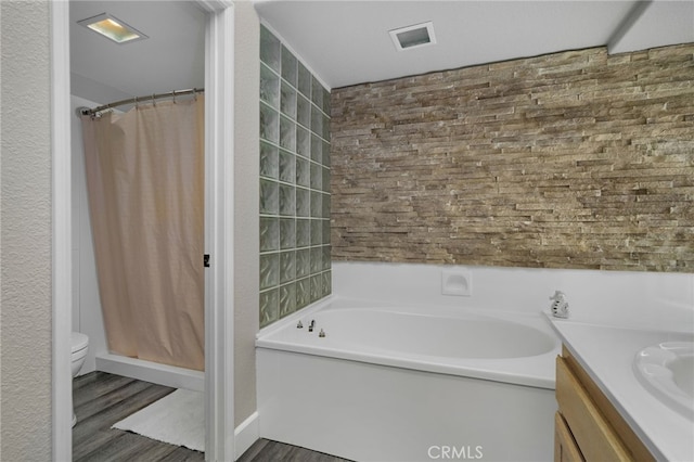 full bathroom featuring vanity, separate shower and tub, toilet, and wood-type flooring