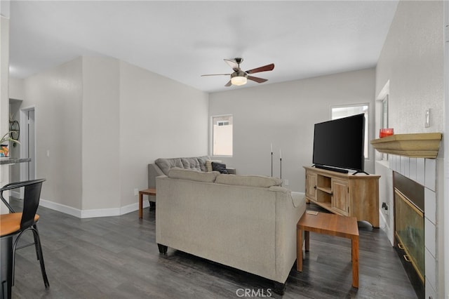 living room featuring dark hardwood / wood-style flooring and ceiling fan