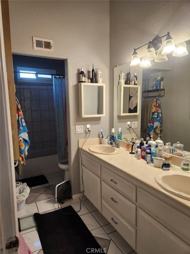 bathroom featuring tile patterned flooring, vanity, and toilet