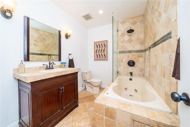 full bathroom with vanity, tiled shower / bath combo, and toilet