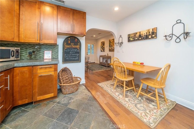 kitchen with decorative backsplash and dark hardwood / wood-style flooring