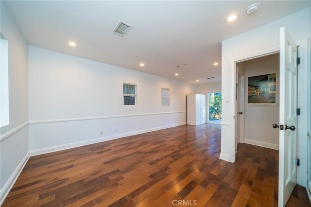 spare room with dark hardwood / wood-style flooring