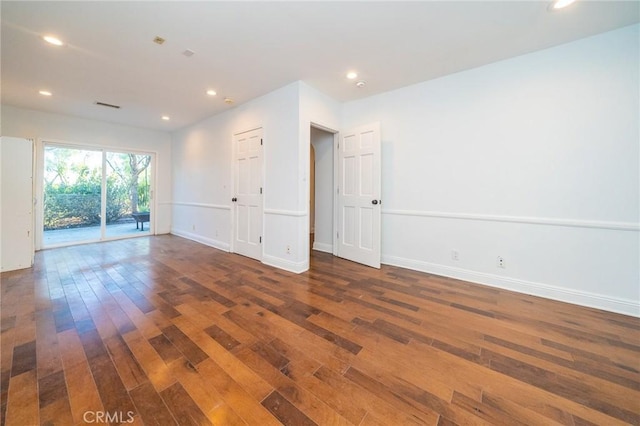 unfurnished room featuring dark wood-type flooring