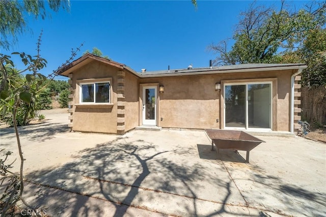 rear view of property featuring a patio area