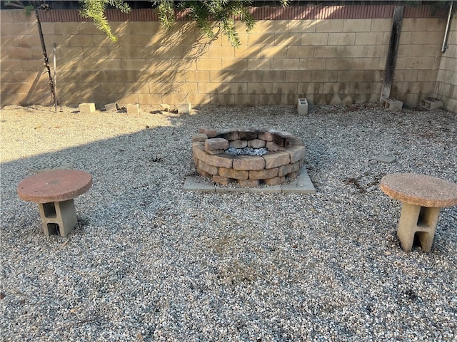 view of yard featuring fence and an outdoor fire pit