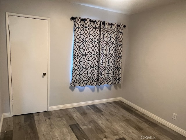 empty room with dark wood-type flooring