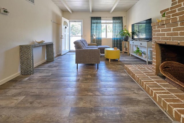 living room with a fireplace, beam ceiling, dark wood-type flooring, and wood ceiling