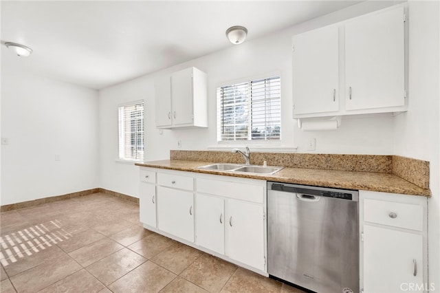 kitchen featuring dishwasher, light tile patterned flooring, white cabinetry, and sink