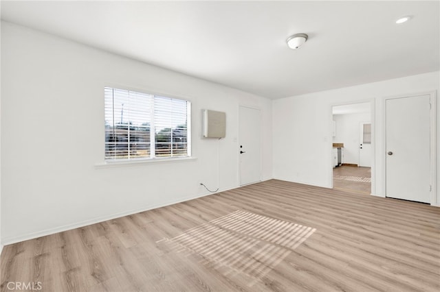 unfurnished room with light wood-type flooring