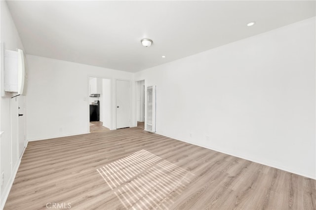 unfurnished room with light wood-type flooring