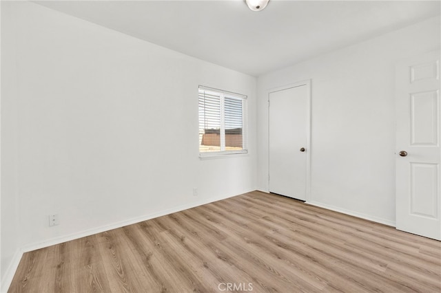 spare room featuring light wood-type flooring