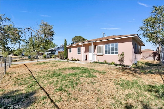 ranch-style home featuring a front yard