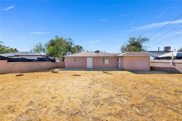 rear view of property featuring a yard