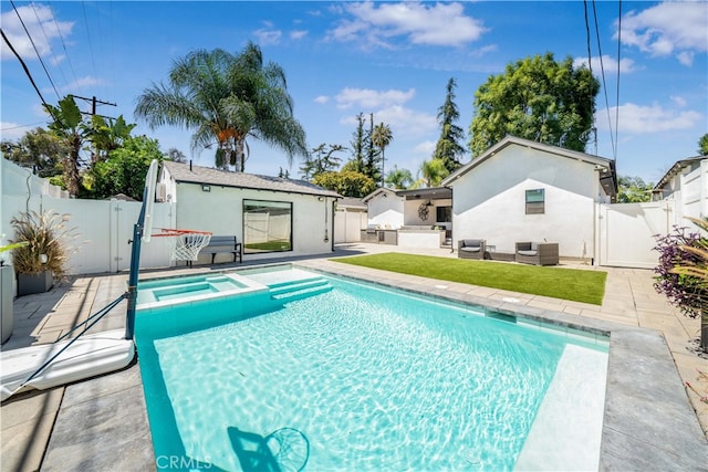 view of swimming pool with an in ground hot tub and a patio area