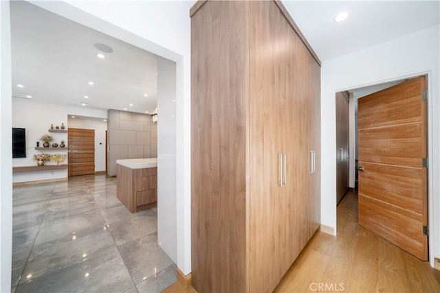 corridor with light hardwood / wood-style flooring