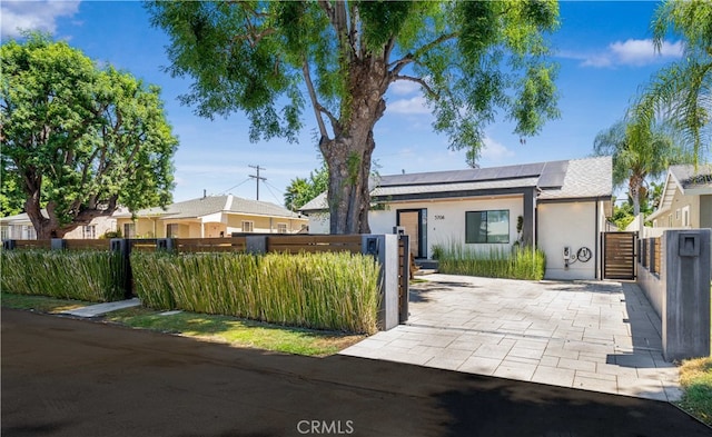 view of front of property featuring solar panels