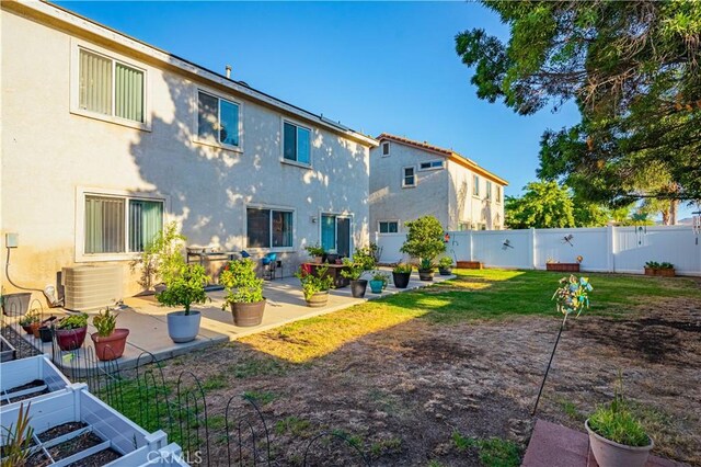 view of yard with central AC unit and a patio