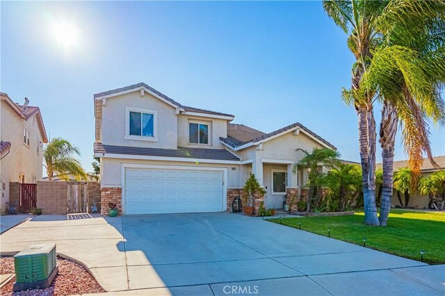 view of front of house with a front yard and a garage