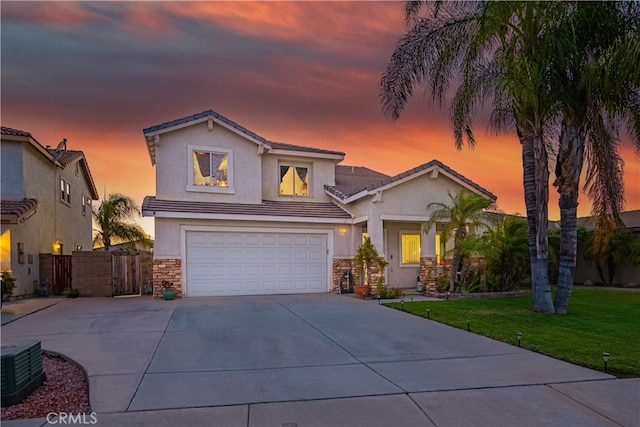 view of front of home featuring a garage and a yard