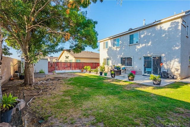 back of property featuring a shed, a lawn, and a patio