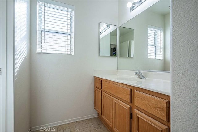 bathroom featuring vanity and a healthy amount of sunlight