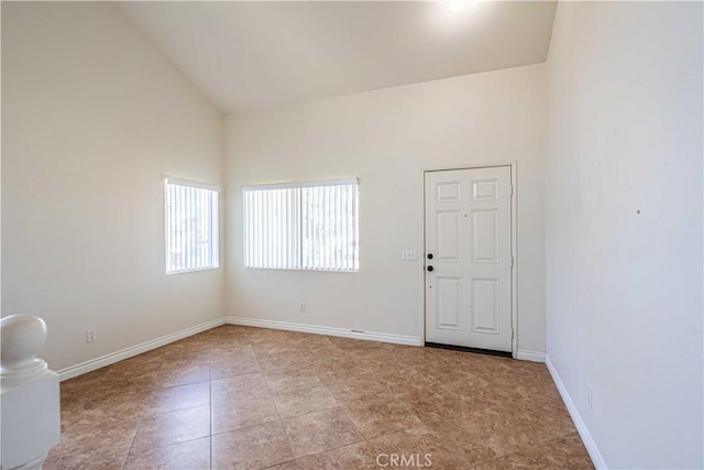 spare room with high vaulted ceiling