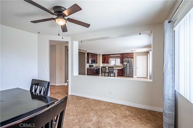 tiled dining area featuring ceiling fan