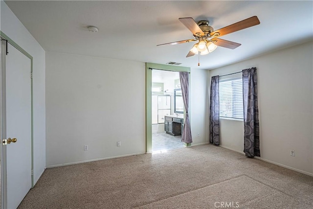 unfurnished room with ceiling fan and carpet flooring