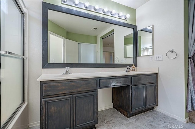 bathroom featuring enclosed tub / shower combo and vanity