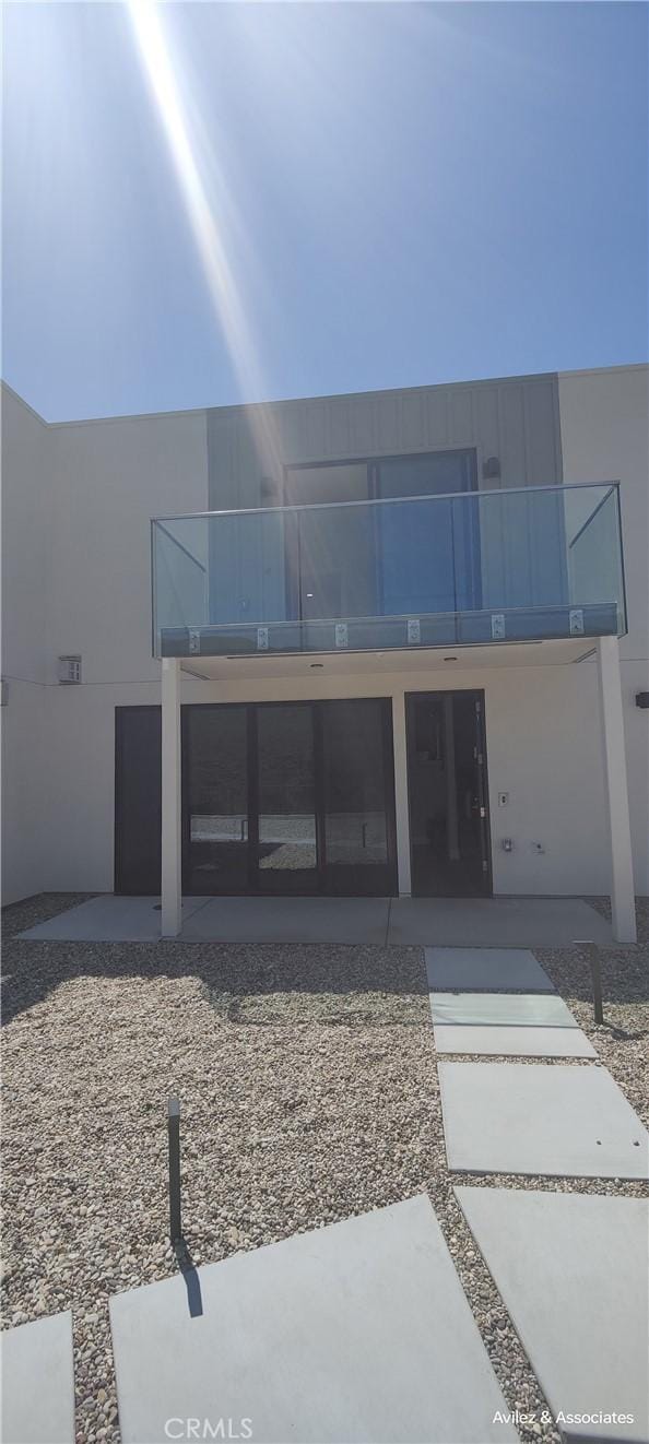 exterior space featuring a patio area and a balcony