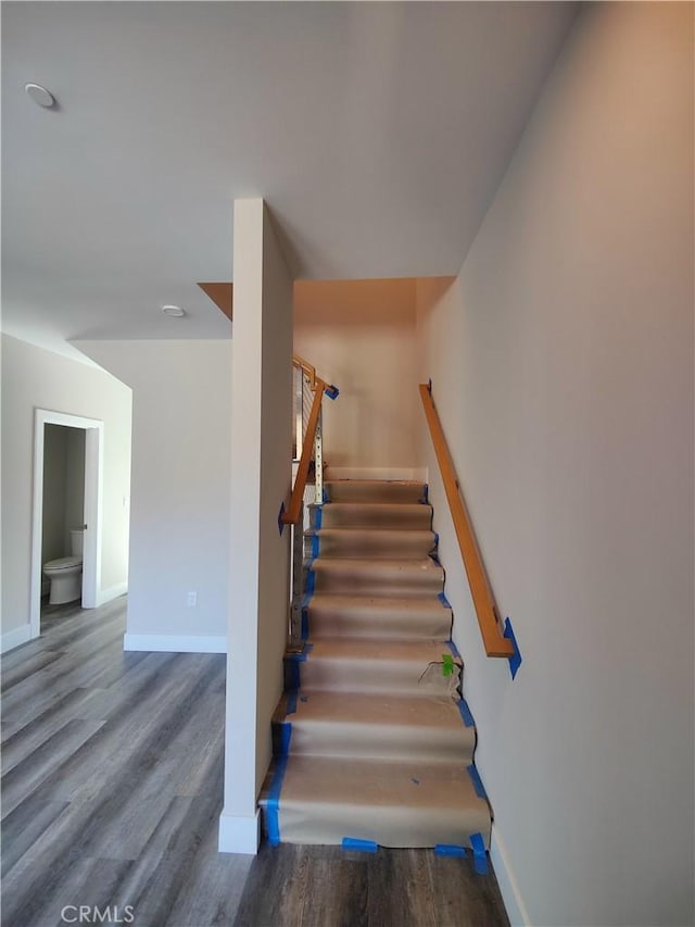 stairs featuring hardwood / wood-style flooring