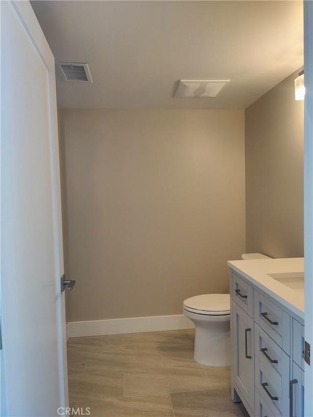 bathroom featuring vanity, hardwood / wood-style flooring, and toilet